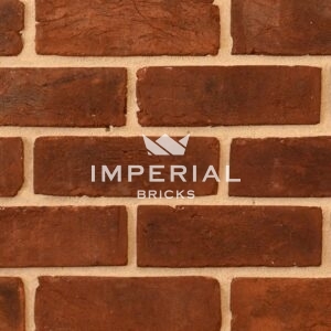 Weathered Red Handmade bricks shown in a wall. The bricks have natural shade variations and a weathered finish.