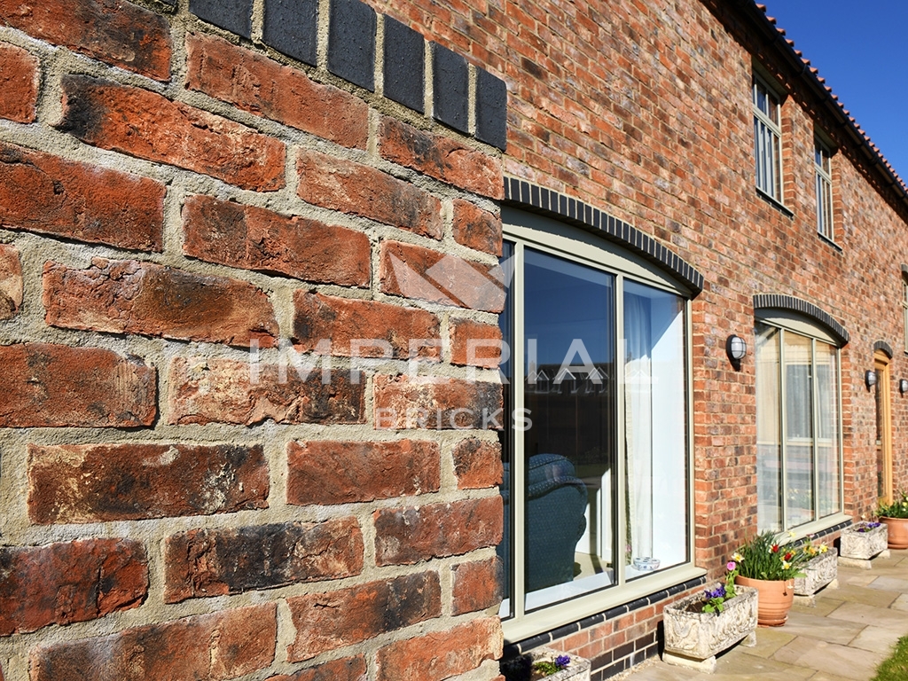 Angled view of the rear of a residential property built using Imperial Bricks' Olde Reclamation Clamp handmade bricks.